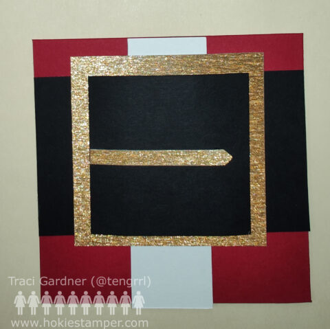 A greeting card that focuses on Santa's belt buckle on a his red suit