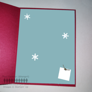 Inside of the card showing blue-green layer on a red background with a small present and snowflake decorations