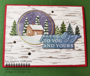 Winter card showing pine trees and a snowy home, with the sentiment Peace and joy to you and yours