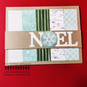 Card front showing vertical strips of patterned paper and the sentiment Noel with a snowflake as the O in the word